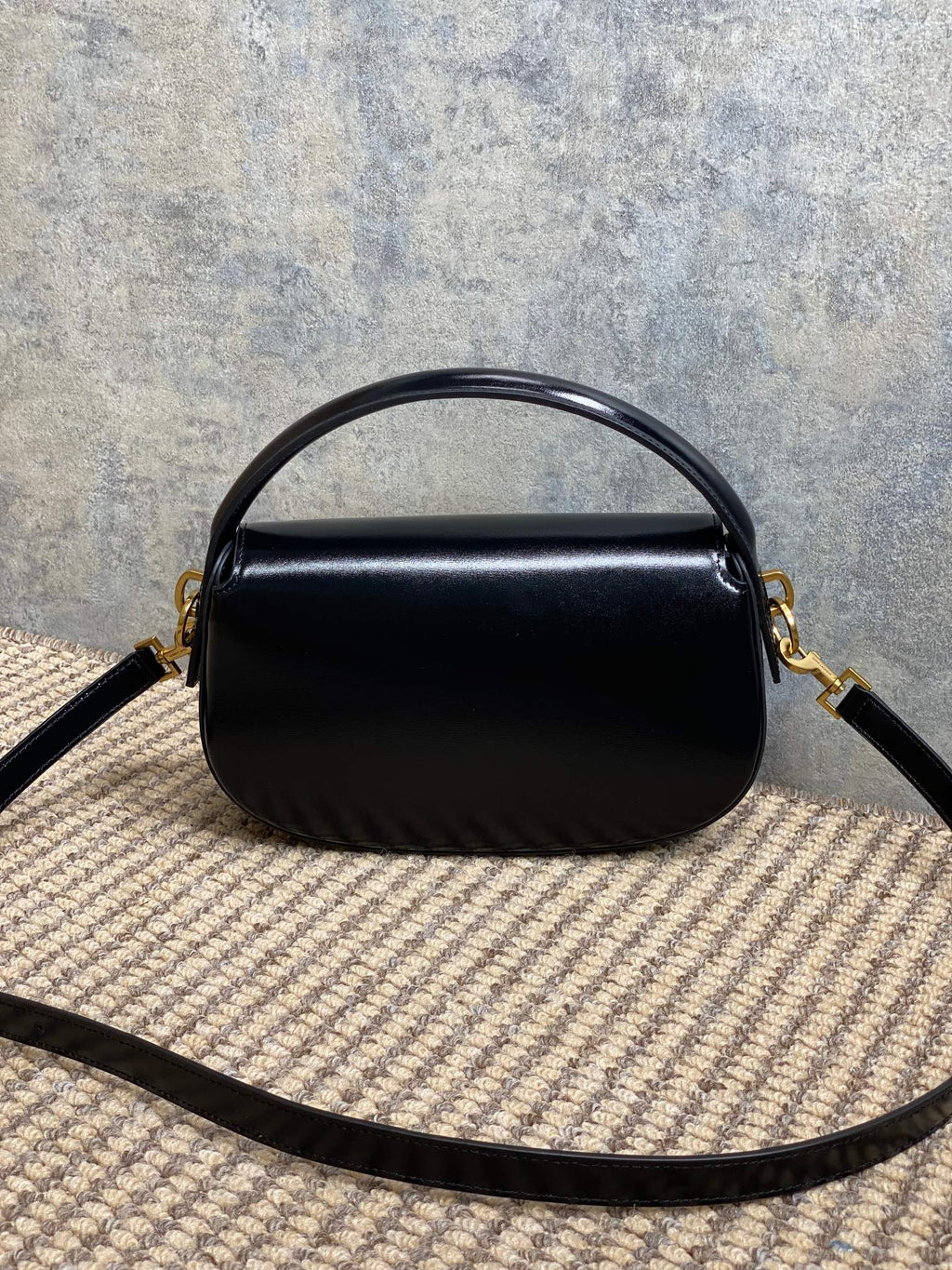 VOLTAIRE HALF-MOON SHOULDER BAG 24 IN BLACK CALFSKIN GOLD METALLIC