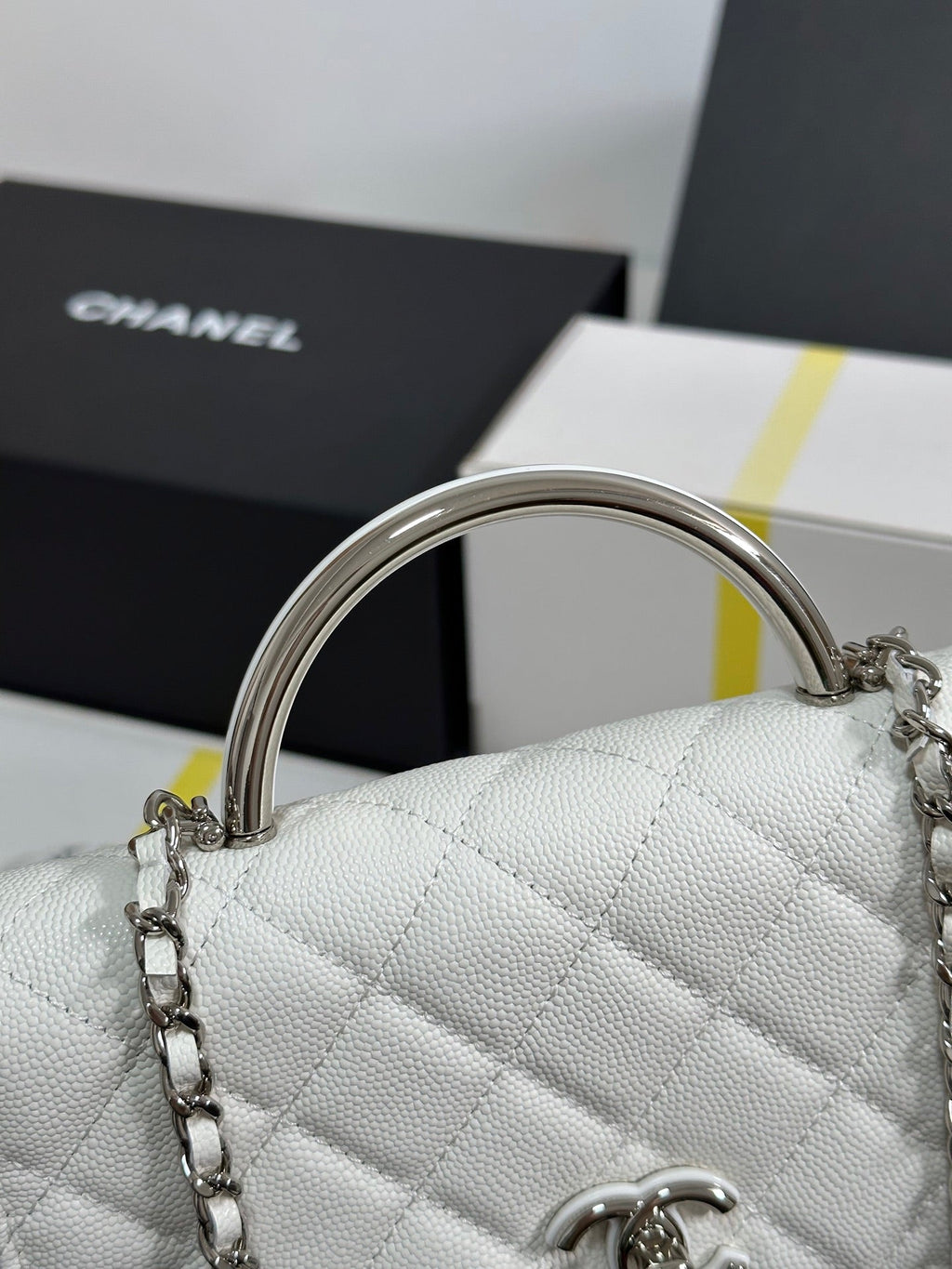 FLAP BAG WITH SILVER-TONE HANDLE 19 IN WHITE CAVIAR SKIN